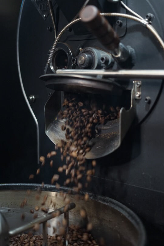 Roaster dropping coffee out of machine